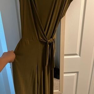 A pant romper that has never been worn and has pockets